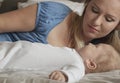 Close-up portrait of mother with her baby on bed in bedroom. Young attractive mom loves her son. Happy family. MotherÃ¢â¬â¢s day Royalty Free Stock Photo